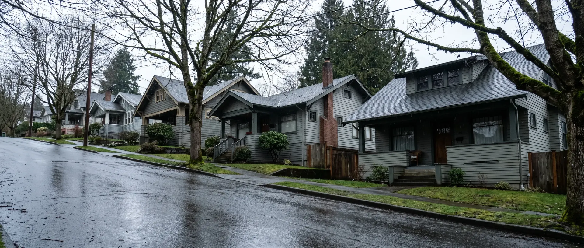 Street of pre 1940 Craftsman bungalows on a Bellingham hillside in winter rain